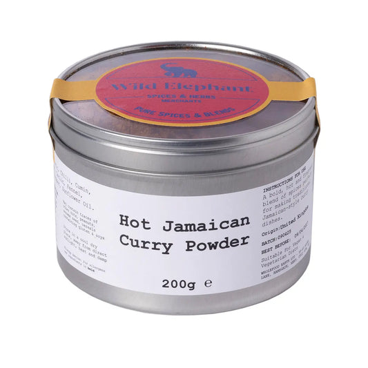 Wild Elephant hot Jamaican curry powder in a spice jar, vibrant orange seasoning for flavorful cooking.