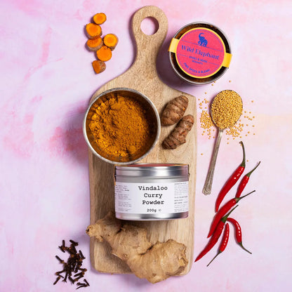 Wild Elephant Vindaloo Curry Powder from Whole Food Earth, a vibrant blend of spices in a jar for flavorful Indian dishes.
