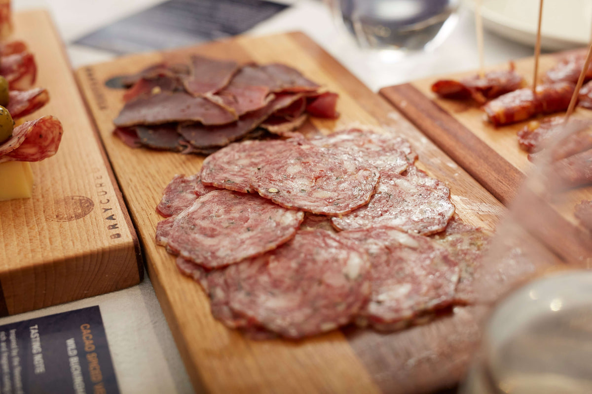 Assorted cured meats and cheeses on a charcuterie board with Bray Cured Charcuterie Course Preview Pack selection.