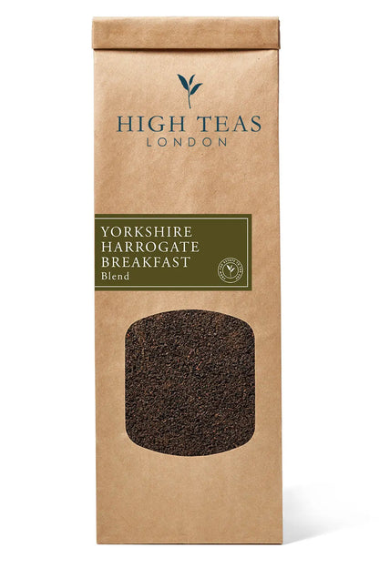 Loose leaf Yorkshire Harrogate breakfast brew tea by High Teas in a clear glass jar with fresh tea leaves visible.