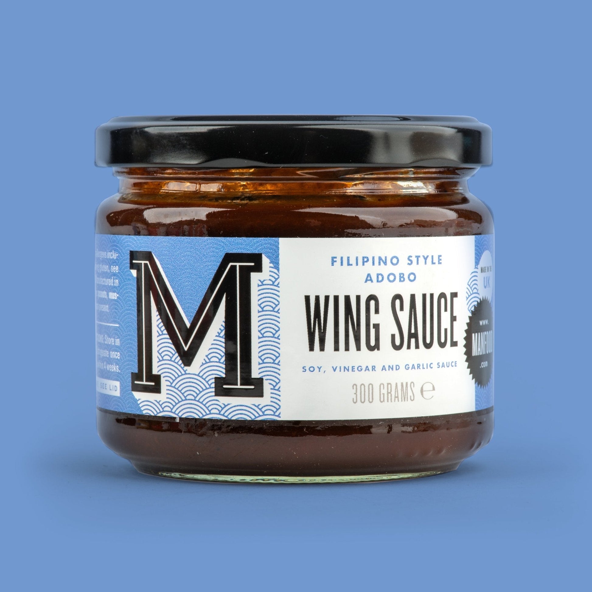 Manfood Adobo Wing Sauce in a bottle, showcasing the rich, flavorful sauce ideal for wings and grilling.