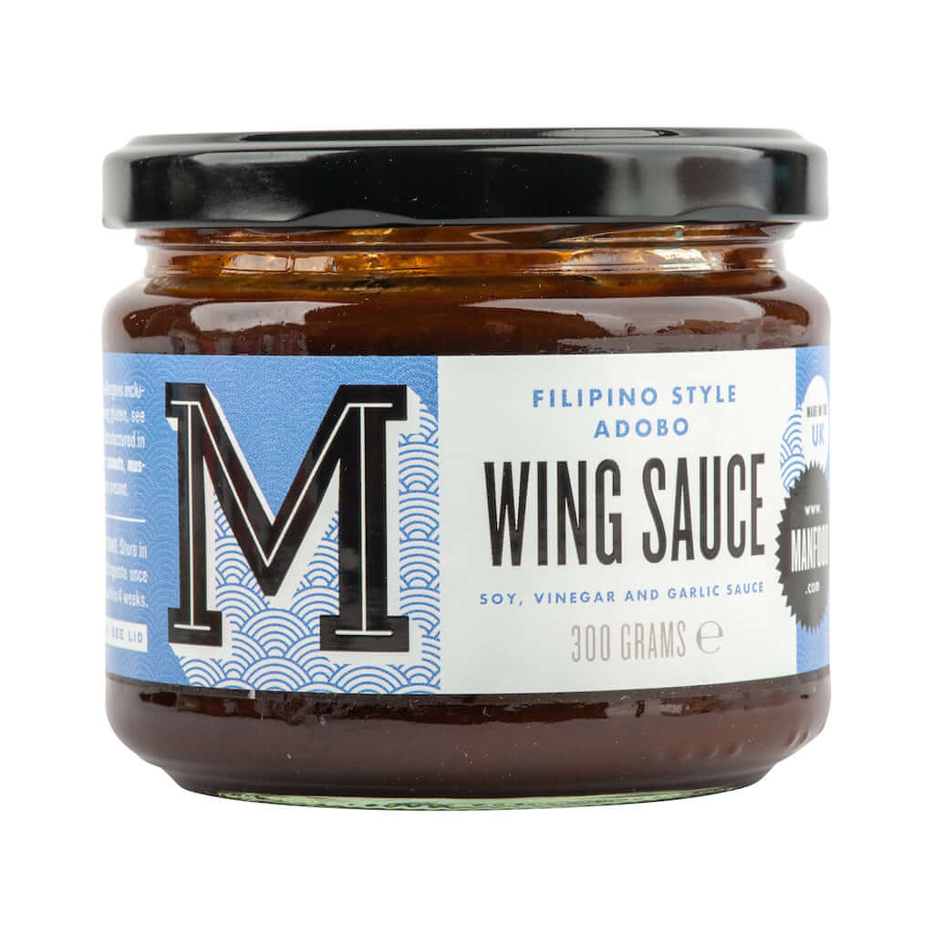 Bottle of Manfood Adobo Wing Sauce showing the label and dark sauce inside the bottle for flavorful chicken wings.