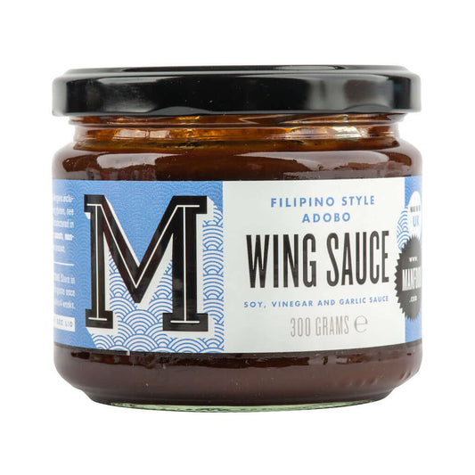 Bottle of Manfood Adobo Wing Sauce showing the label and dark sauce inside the bottle for flavorful chicken wings.