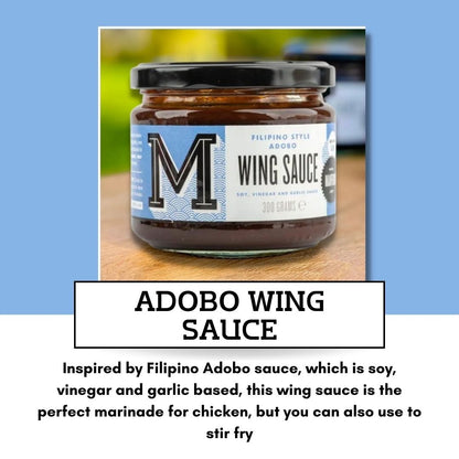 Bottle of Manfood Adobo Wing Sauce with a red label, showcasing the spicy, flavorful sauce for chicken wings on a white background.