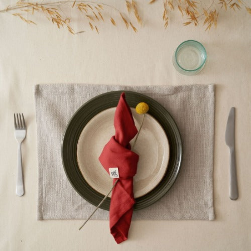 Set of four organic cotton napkins by Wild and Stone, soft natural fabric with stitched edges for elegant table setting.