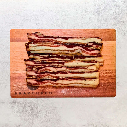 British Charcuterie Pizza Pack by Bray Cured featuring air-dried bacon and pancetta on a charcuterie selection board.