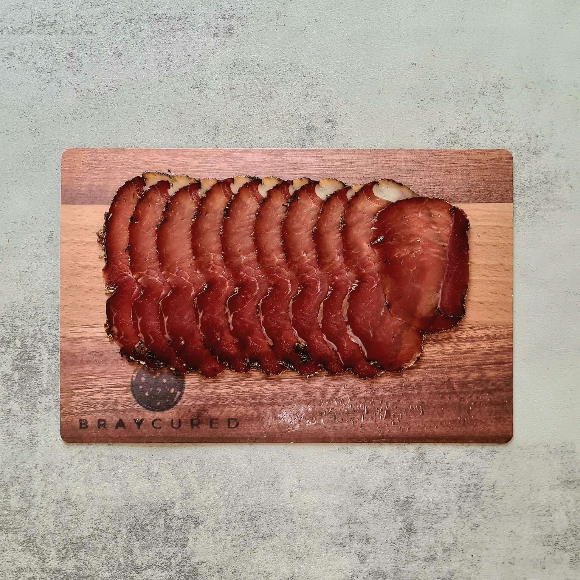 British Charcuterie Pizza Pack featuring Bray Cured air-dried ham slices on a wooden board with assorted charcuterie selection