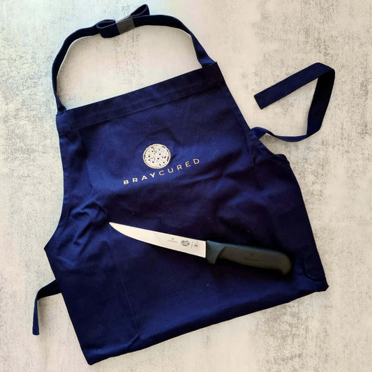 Bray Cured charcuterie apron and butcher's knife gift set, including a durable apron and sharp knife for meat preparation.