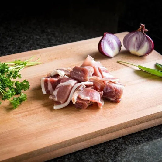 Sliced bacon off-cuts from Primrose Herd, showing crispy, flavorful bacon pieces on a white background.