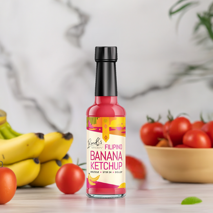 RoniB's Kitchen Filipino Banana Ketchup bottle with bananas and tomatoes, showcasing the 150ml jar and fresh ingredients.