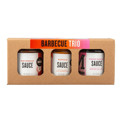 Manfood BBQ Trio gift box featuring three assorted barbecue sauce bottles on a wooden surface.
