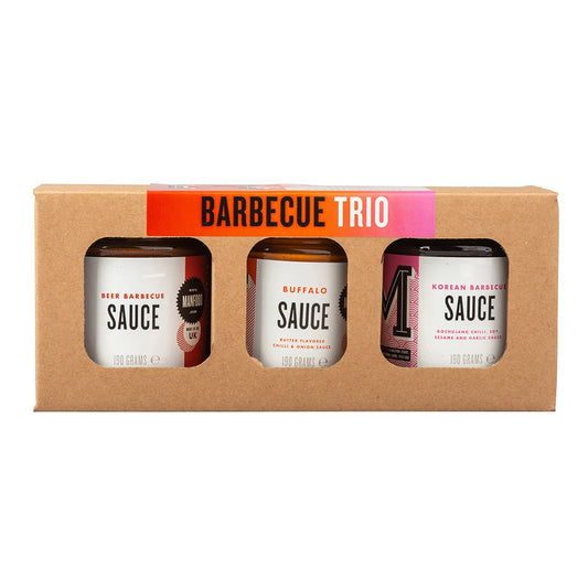 Manfood BBQ Trio gift box featuring three assorted barbecue sauce bottles on a wooden surface.