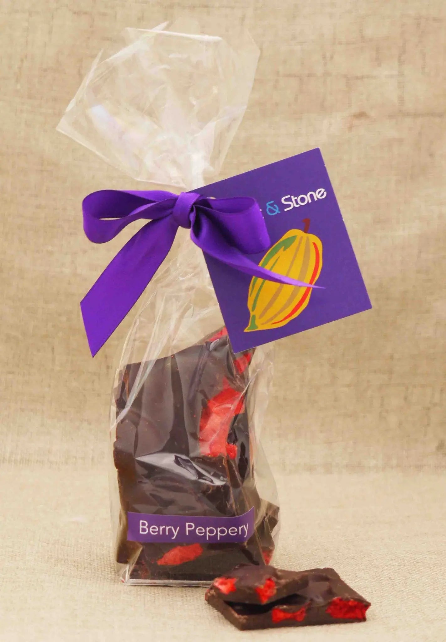 Handmade Gorvett & Stone Berry Peppery 70% dark chocolate shards in packaging, showcasing rich, textured chocolate pieces.