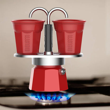Red Bialetti Mini Express 'R' double serve coffee maker by Brew Italia, compact Italian hardware for two cups of fresh espresso.