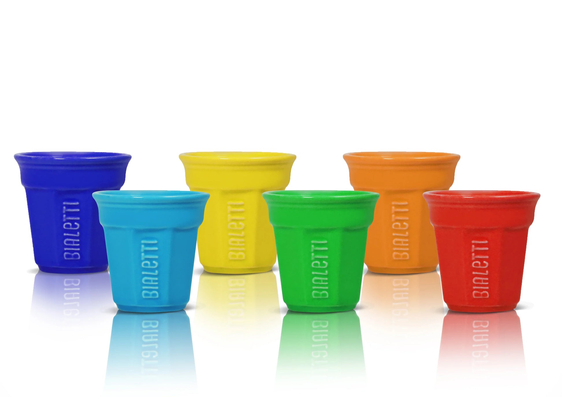 Set of six Bialetti espresso cups in various colors, made by Brew Italia, displayed on a wooden surface.