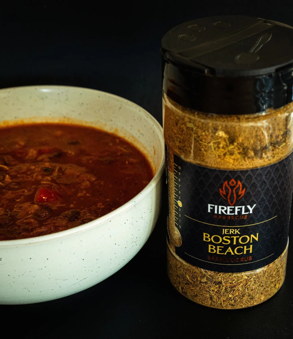 FireFly Barbecue Boston Beach Jerk Rub BBQ seasoning jar with a label, ideal for grilling and adding spicy flavor to meats