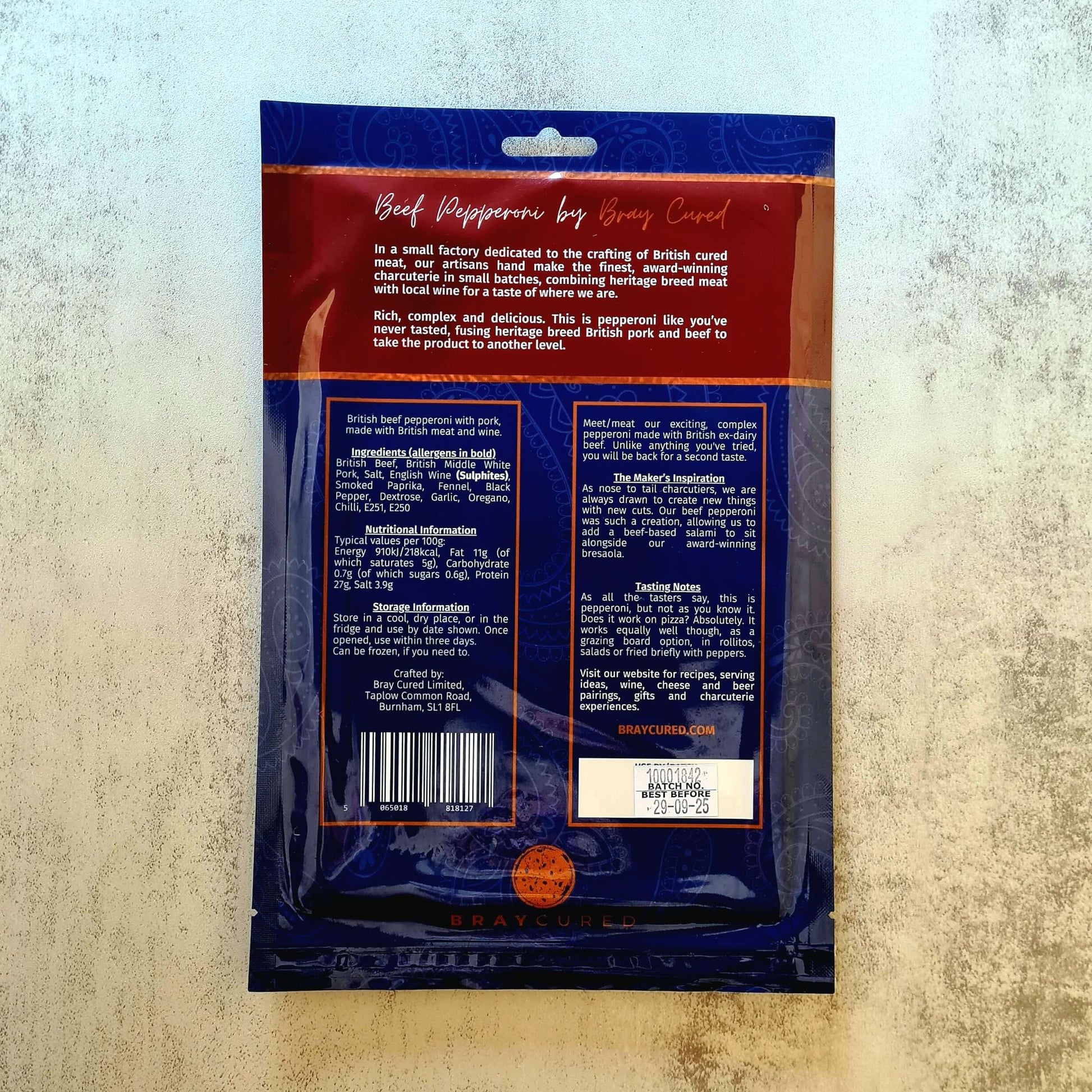 British beef pepperoni pack from Bray Cured, featuring slices of cured beef pepperoni on a wooden board.