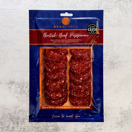 British Pepperoni charcuterie pack by Bray Cured, featuring slices of seasoned British beef pepperoni on a wooden surface.