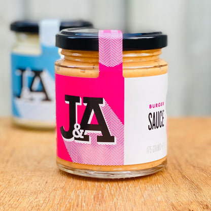 Janda burger sauce in a jar, creamy and flavorful condiment for burgers, with a smooth, rich texture and golden color.
