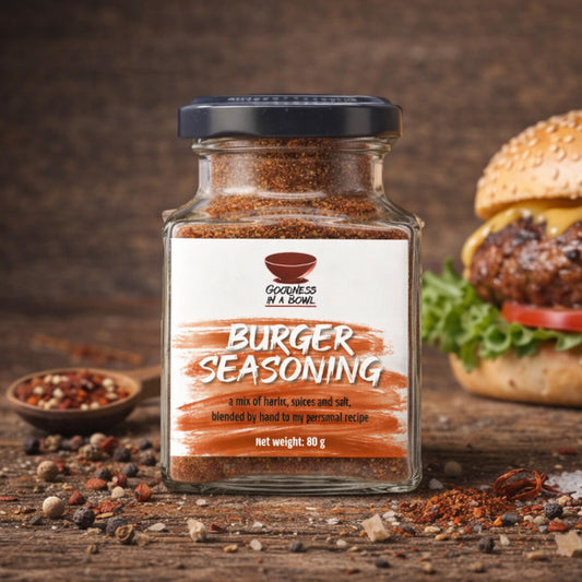Close-up of GOODNESS IN A BOWL burger seasoning rub in a jar, showing the seasoned spice blend for burgers and grilling.