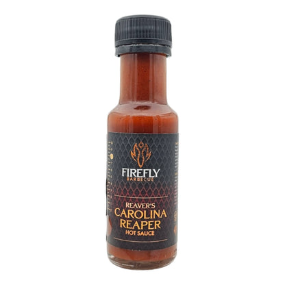 FireFly Barbecue Carolina Reaper Hot Sauce bottle with bright label, showcasing fiery red chili peppers and bold spicy flavor details.