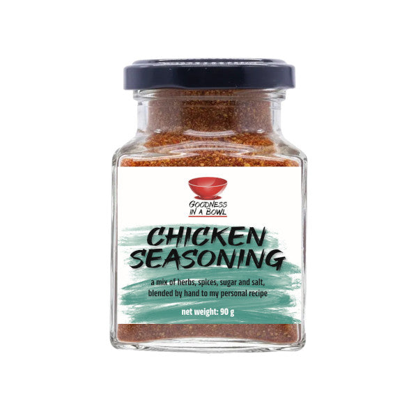 Close-up of GOODNESS IN A BOWL chicken seasoning rub in a jar, showing the seasoned chicken with herbs and spices.