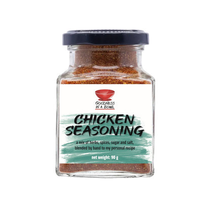 Close-up of GOODNESS IN A BOWL chicken seasoning rub in a jar, showing the seasoned chicken with herbs and spices.