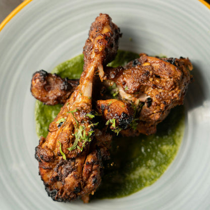 Goodness in a Bowl chicken seasoning rub in a jar, with a close-up of the seasoned chicken showing herbs and spices.