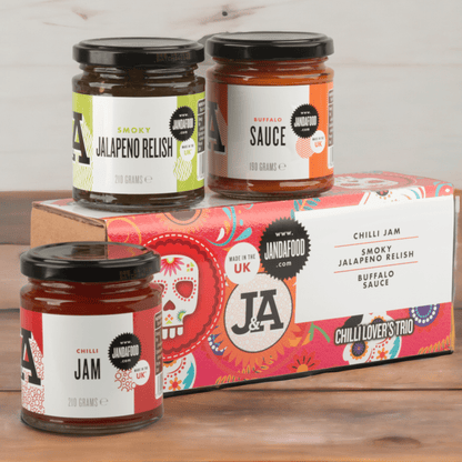 Janda Chilli Lover's Trio gift box with three varieties of fresh red and green chillies on a white background.