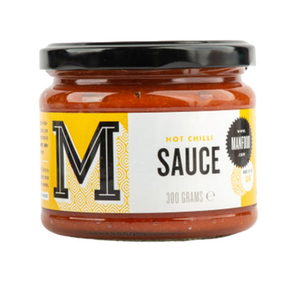 Spicy Manfood Chilli Sauce in a glass bottle with red chili peppers, showcasing the flavorful sauce for dishes and dips.