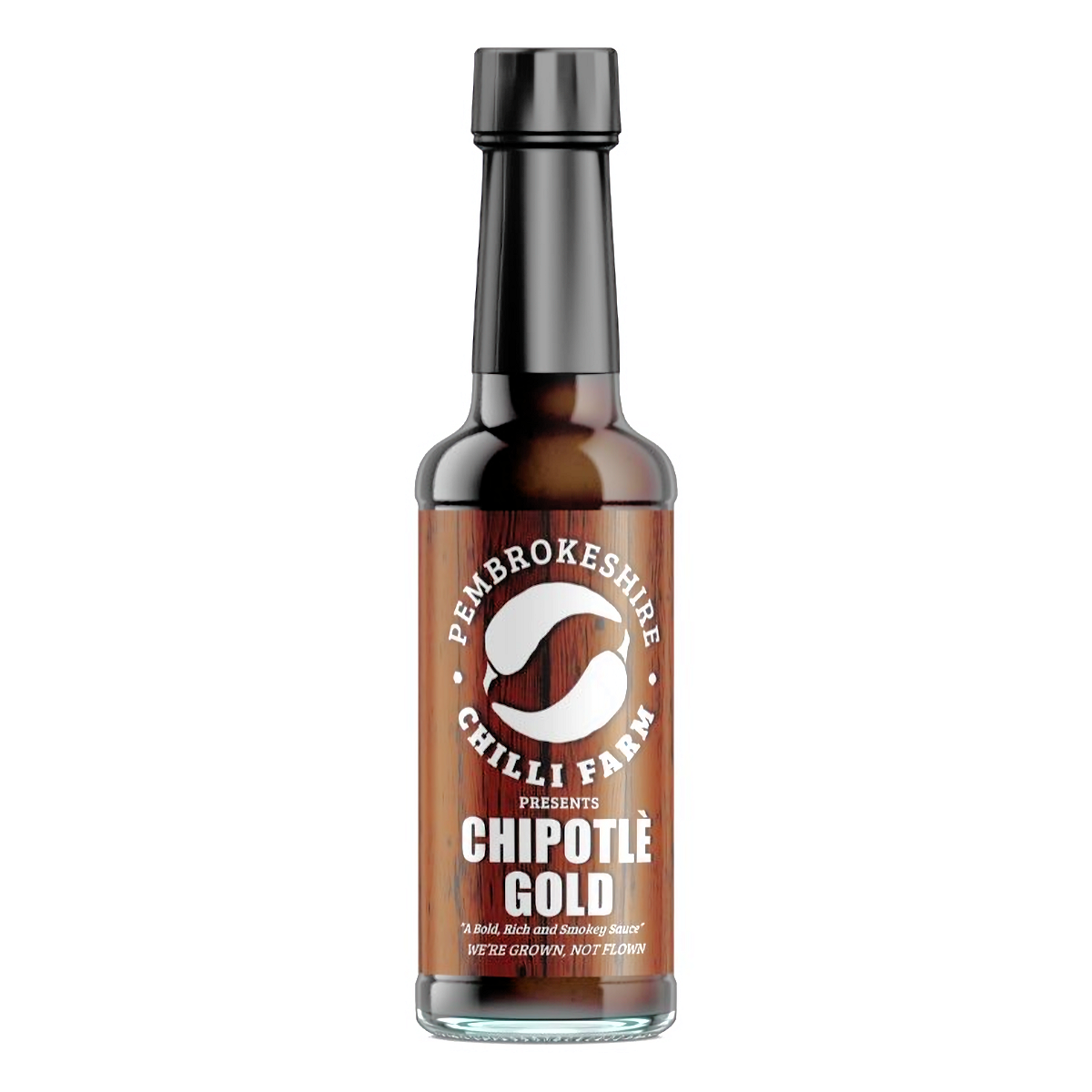 Bottle of Pembrokeshire Chilli Farm Chipotle Gold Chilli Sauce with golden hue, label visible, and chili peppers in the background.