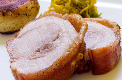 Cooked pork loin joint from Primrose Herd Half Pig Pork Box, showcasing a tender, sliced meat cut ready for serving.