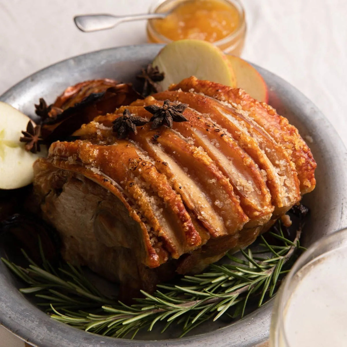 Cooked Cornish outdoor-reared boneless rolled pork shoulder joint by Primrose Herd, showcasing a juicy, well-cooked pork joint.