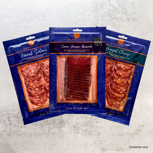 Assorted charcuterie slices and accompaniments on a wooden board, featuring Bray Cured's charcuterie Course Preview Pack.