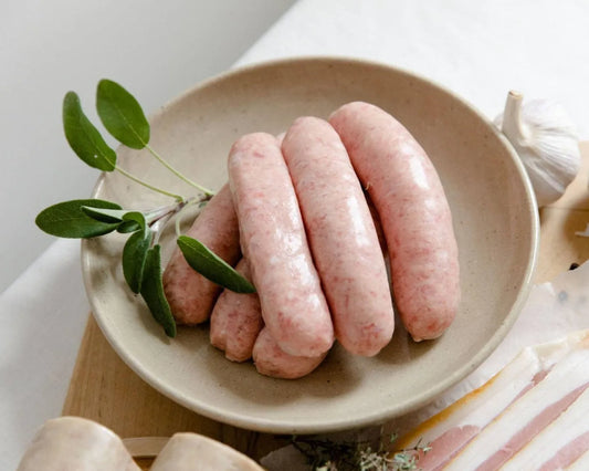Primrose Herd Cumberland sausages cooked and ready to serve, showcasing their juicy, flavorful interior and traditional casing.