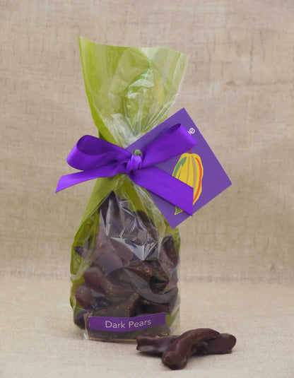 Dark chocolate-covered pear by Gorvett & Stone, showcasing a glossy chocolate coating over a fresh pear.