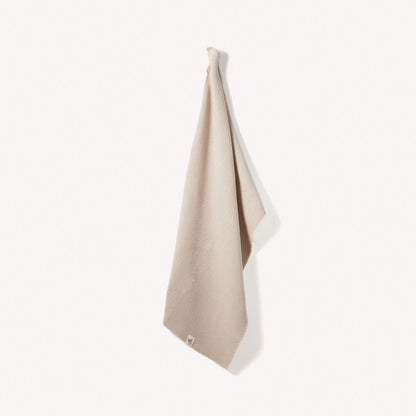 Organic Cotton Hand Towels by Wild And Stone, soft and absorbent, displayed hanging with natural texture and neutral tones.