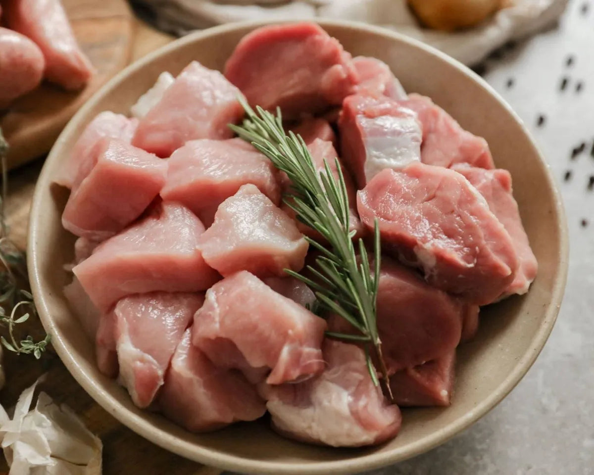 Cubed diced pork from Primrose Herd, showing fresh, evenly cut pork meat ideal for cooking or meal preparation.