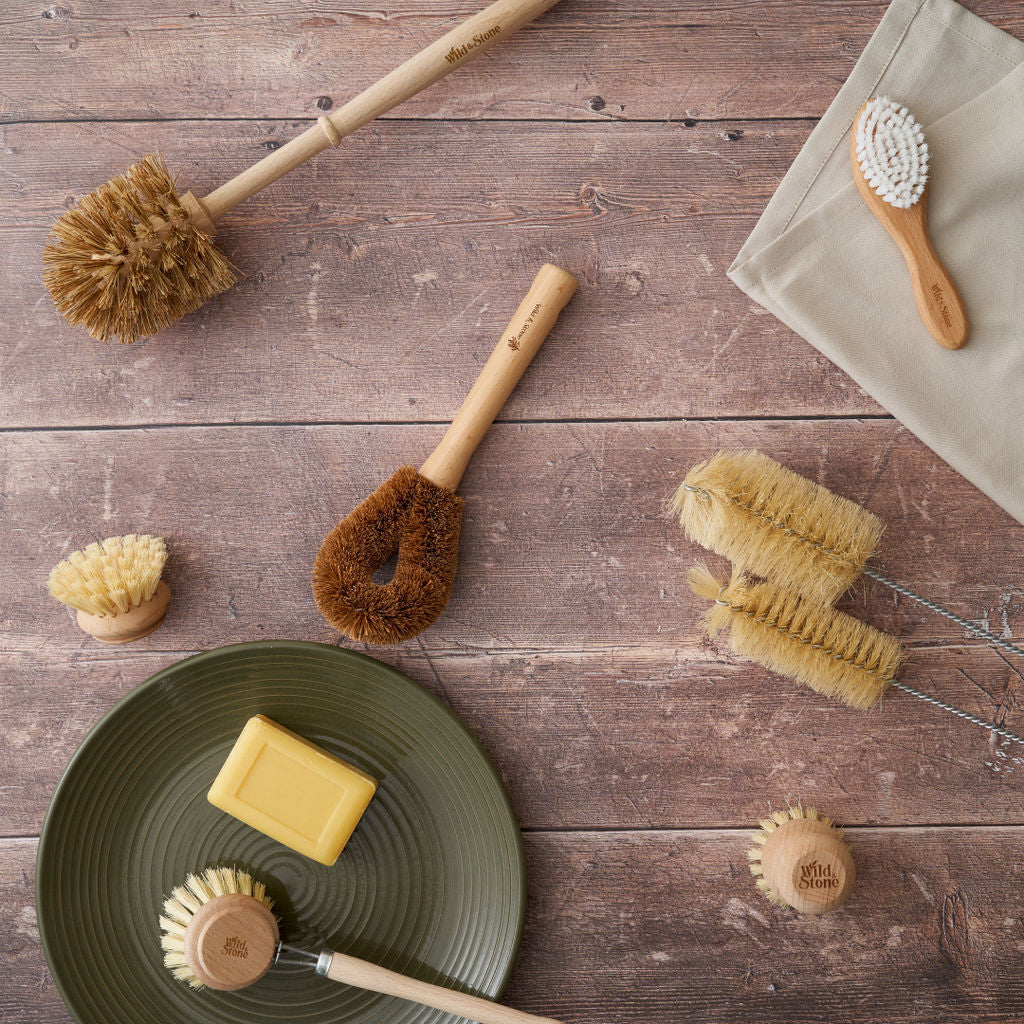 Wooden dish brush with replaceable head by Wild And Stone, showing natural wood handle and replaceable cleaning brush.