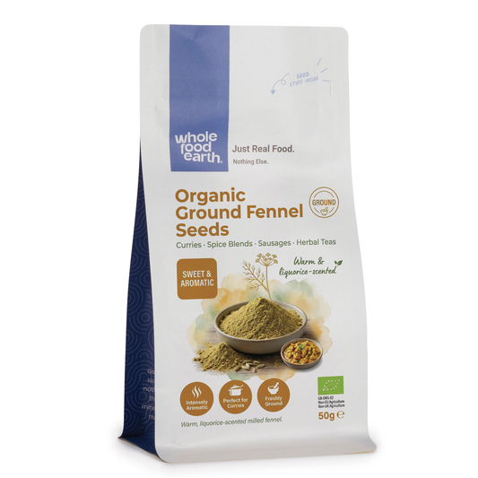 Organic ground fennel seeds from Whole Food Earth, close-up of fine, yellowish-brown spice in a clear container.