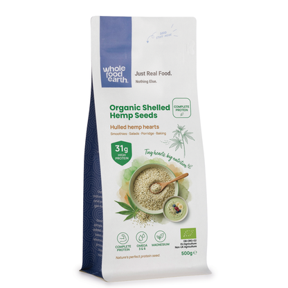 Organic shelled hemp seeds from Whole Food Earth, close-up view of small, greenish seeds in a clear container.