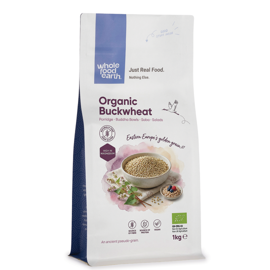 Organic buckwheat grains in a clear bag, showing their earthy brown color and small, triangular shape from Whole Food Earth.