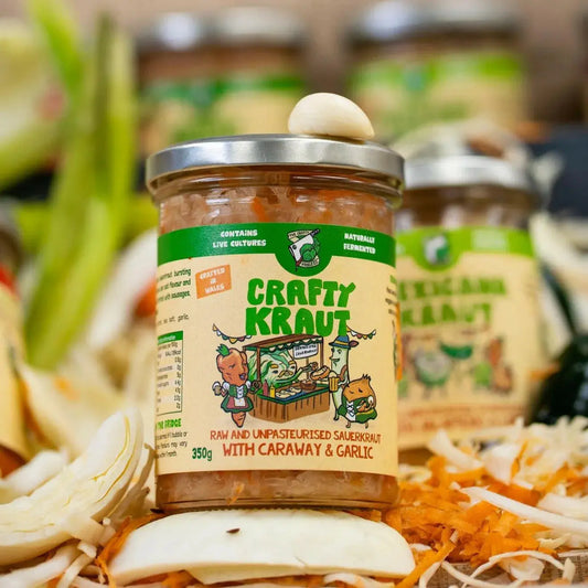 Jar of Crafty Kraut with Caraway and Garlic from Crafty Pickle Co., showcasing tangy, fermented sauerkraut with caraway seeds and garlic.