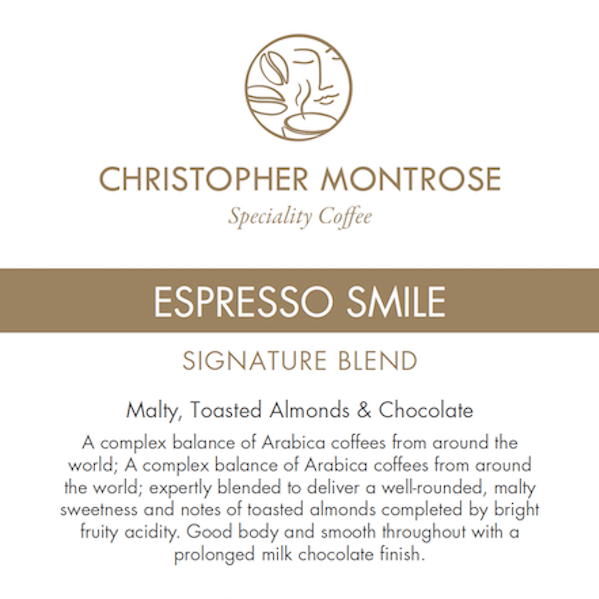 Bag of Christopher Montrose Coffee Arabica Espresso Smile coffee beans with a colorful label featuring a smiling face.