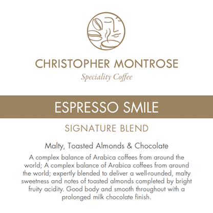 Bag of Christopher Montrose Coffee Arabica Espresso Smile coffee beans with a colorful label featuring a smiling face.