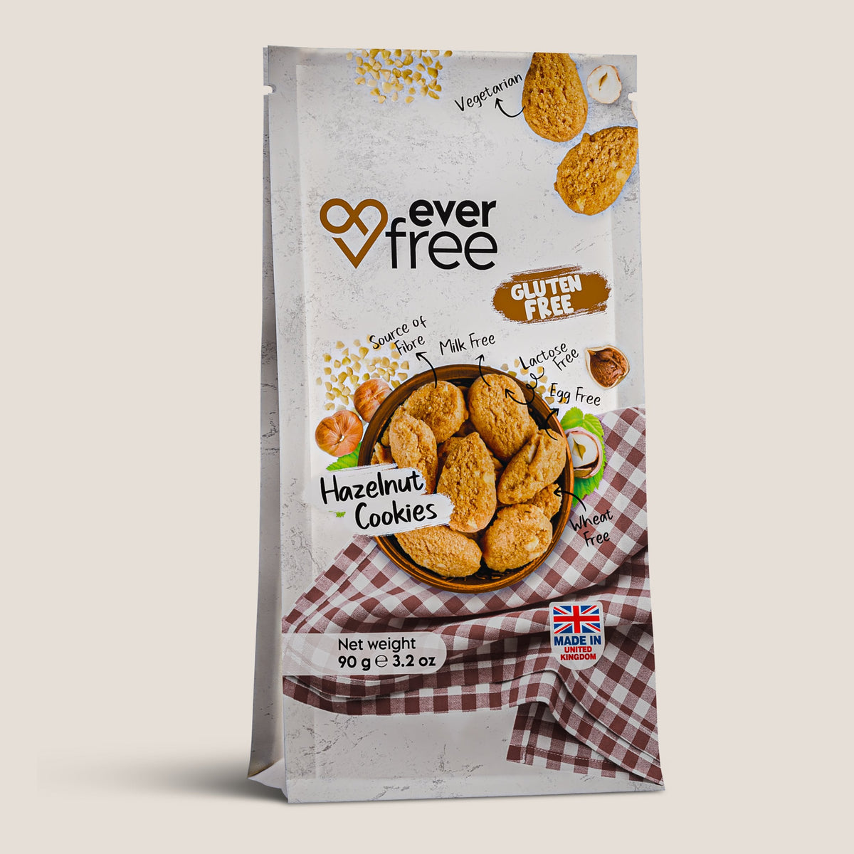 Three EverFree gluten-free hazelnut cookies in packaging, showcasing the nutty, crunchy snack with hazelnut pieces visible.