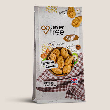 Three EverFree gluten-free hazelnut cookies in packaging, showcasing the nutty, crunchy snack with hazelnut pieces visible.