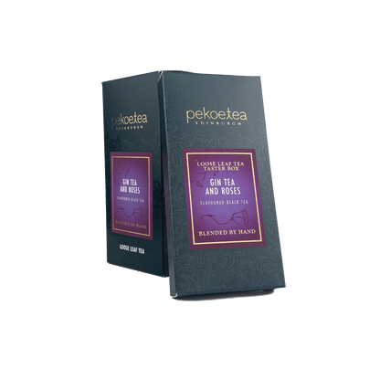 Box of PekoeTea Edinburgh Gin Tea and Roses flavored tea with a floral and herbal blend in a decorative tin packaging.
