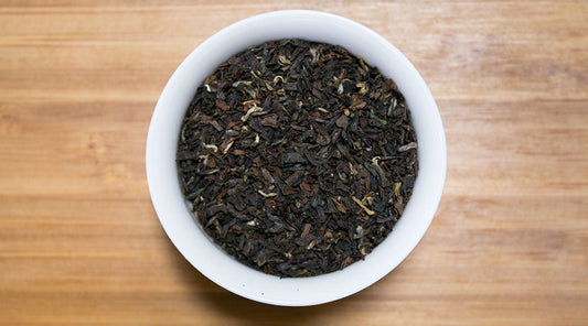 Gopaldhara TGBOP Second Flush Darjeeling tea leaves from PekoeTea Edinburgh, showcasing fresh, golden-brown tea leaves in a clear container.
