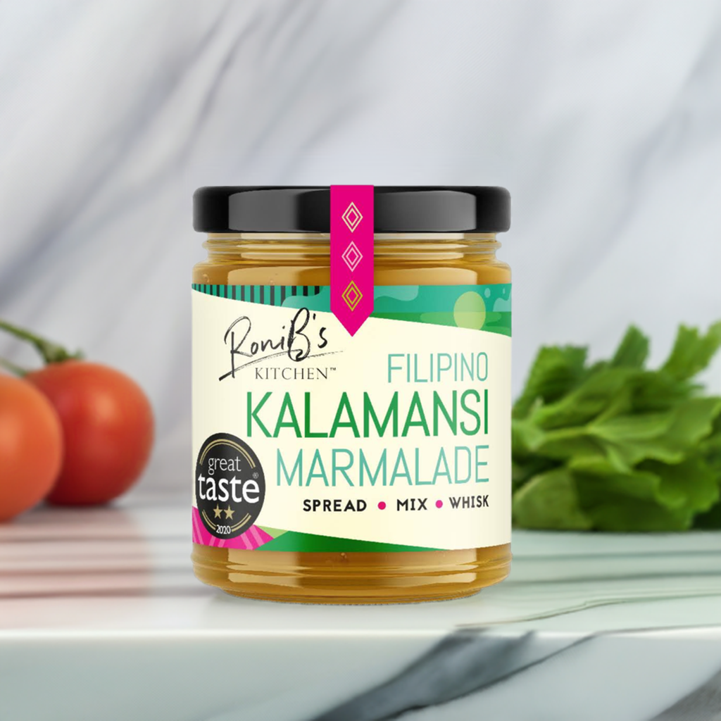 RoniBs Kitchen Filipino Kalamansi Marmalade with Don Papa Rum in a jar, showcasing vibrant orange marmalade with a spoon.